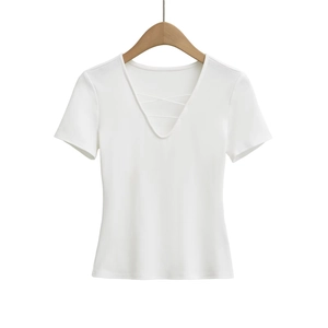 Detail of white V-neck ribbed top with crisscross strap design on wooden hanger