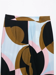 Close-up of geometric pattern print on high-waisted wide-leg pants in black and pink