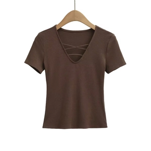 Detail of deep V-neckline with cross strap design on dark brown short sleeve top