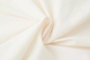 Close-up detail showing the fine texture and soft folds of white linen cotton fabric
