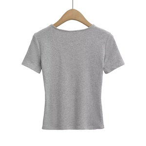 Detailed view of light grey V-neck short sleeve top on a wooden hanger with soft fabric texture