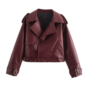 Detail of burgundy faux leather biker jacket featuring wide lapels and silver metal buckles