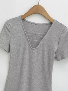 Detail of light gray v-neck knit top featuring stylish criss-cross lace-up design