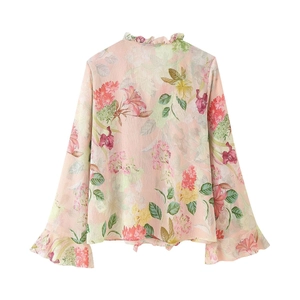 Close-up of floral print chiffon blouse with ruffle stand collar and trumpet cuffs detail
