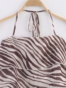 Detailed view of coffee zebra print halter top with ruffled layers on a hanger