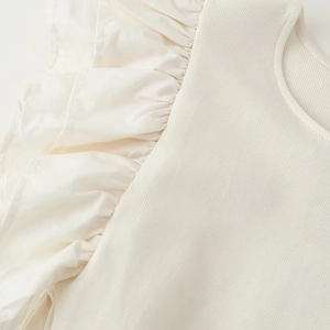 Ivory knit dress featuring ruffled shoulder details and fine ribbed texture fabric