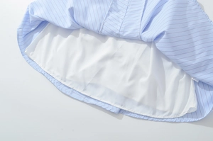 Detail view of double-layer light blue striped fabric with soft white inner lining
