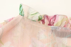 Close-up of floral chiffon blouse neckline with delicate ruffles and sheer fabric texture