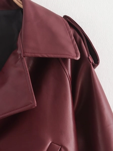 Detail view of burgundy PU jacket featuring a neat lapel and shoulder epaulettes detail