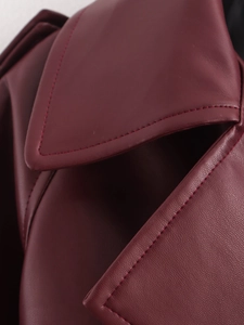 Detailed close-up of dark wine red PU leather jacket showing fine stitching and smooth texture