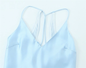 Detail of light blue satin midi dress with delicate thin straps and a soft V-neckline