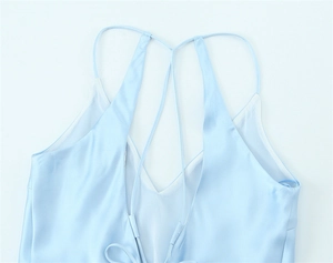 Close-up of light blue satin midi dress with V-neckline and crisscross back straps