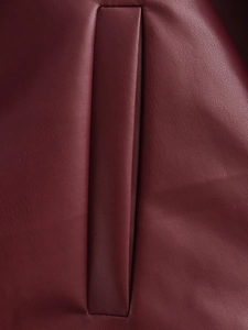 Close-up of the burgundy leather jacket featuring premium pebbled texture and side pocket