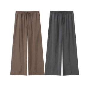 Detailed texture of brown and grey wide-leg trousers with drawstring elastic waistband