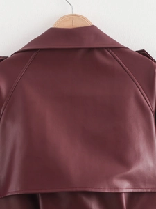 Detail view of the back of a burgundy faux leather jacket with high-quality stitching