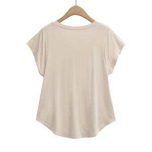 Close-up of beige short-sleeved t-shirt with classic crew neck and curved hem detail