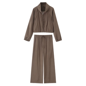 Flat lay of a two-piece dark brown track suit featuring a zip-up jacket and wide-leg pants