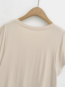 Detail of the crew neck and soft beige knitted fabric of this casual short sleeve top