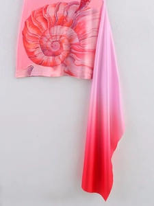 Detail of pink gradient dress featuring shell print and elegant side draped sash