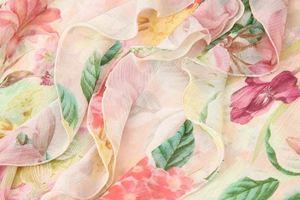 Detail of floral print chiffon blouse with delicate layered ruffles and soft texture