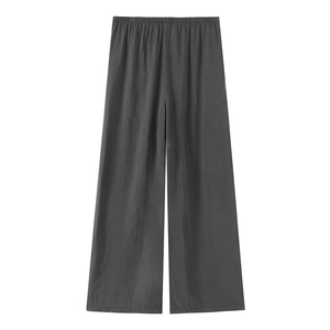 Detail view of dark grey wide-leg trousers featuring elastic waistband and textured fabric