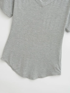 Detailed view of women's dark grey V-neck T-shirt featuring a stylish curved scalloped hem