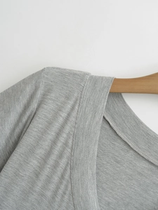 Detail of the high-quality stitching on gray knitted short sleeve shirt neckline