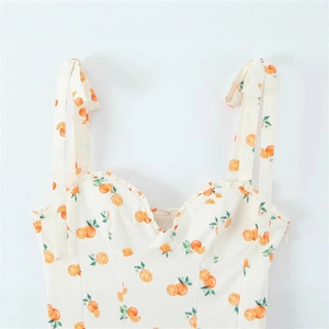 Cream poplin dress with orange fruit print, tie straps, and ruffled sweetheart neckline