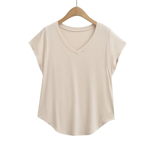 Women's V-neck short sleeve top in apricot with curved hem on a wooden hanger