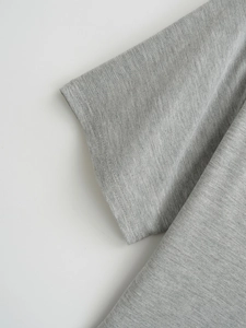 Close-up of sleeve cuff with double-needle stitching on grey knit t-shirt fabric