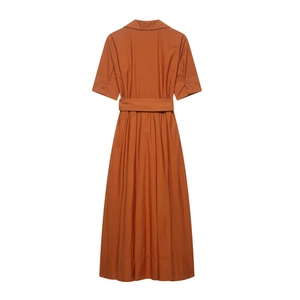 Detail view of the burnt orange short-sleeve shirt dress with belt and lapel collar