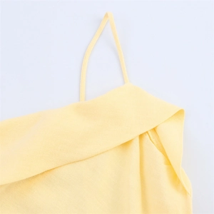 Close-up of a light yellow ramie-blend dress showing fine texture and strap details