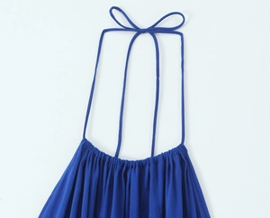 Detail of royal blue halter midi dress featuring pleated neckline and thin bow straps