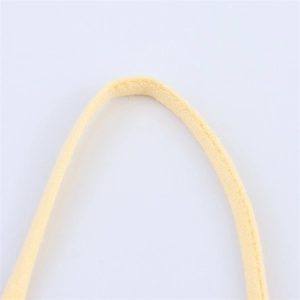 Detailed macro view of yellow ramie blend fabric straps with clean stitching and fine texture