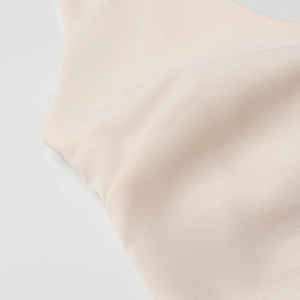 Detailed macro view showing the high-elasticity beige knit fabric texture and smooth finish