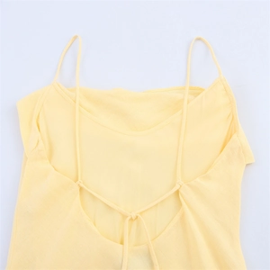 Detail of light yellow ramie-blend dress featuring delicate back tie-up and deep V-neck cut