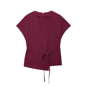 Detail view of wine red short sleeve wrap top with side tie and deep V-neckline