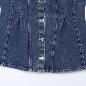 Close-up of deep blue denim tube top featuring metal buttons and pleated waist detail