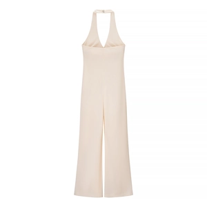 Elegant halter neck wide leg jumpsuit in champagne beige with metallic buckle detail