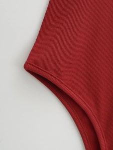 Gros plan détaillé sur un tissu en maille côtelée rouge foncé avec couture à double aiguille