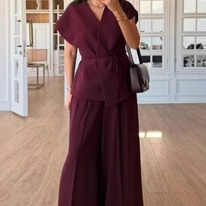 Elegant burgundy two-piece set with V-neck belted top and wide-leg trousers for women