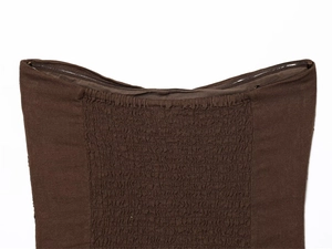 Detail of dark brown smocked tube top showing elastic texture and non-slip silicone band