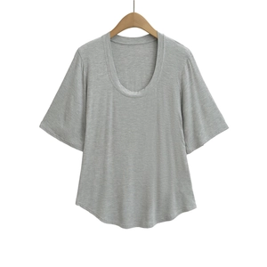 Detail of grey short-sleeve T-shirt featuring a U-neckline and curved hem design