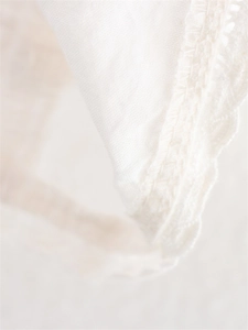 Detailed close-up showing the white lace crochet edging and fine stitching of the camisole