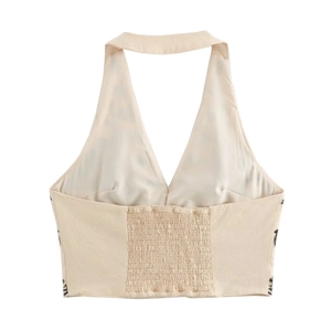 Beige halter crop top with smocked back and side prints, flat lay minimalist display