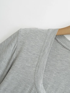 Detail shot of the gray knit top showing neck seam and cotton blend fabric texture