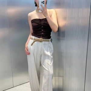 Women's brown ruched tube top and off-white striped wide-leg pants with woven belt