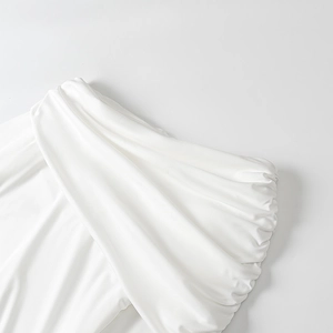 Elegant white draped dress with ruched details and silky fabric for spring 2025 fashion