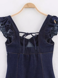 Detailed back view of dark blue denim dress featuring ruffle straps and lace-up back