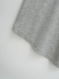 Close-up of gray knitted T-shirt hem with professional double-needle flat stitching